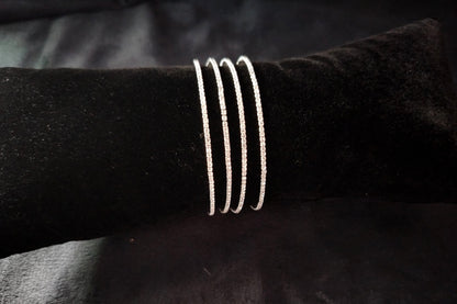 Set of 4 AD Bangles on Black Velvet Cushion