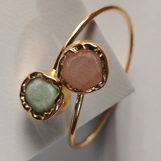 Golden Bracelet with Pink and Mint  Natural Stones on an Off-white Background