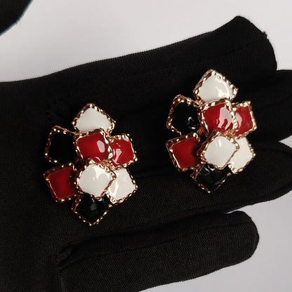Hands Holding Stacked Square Motif Earrings with Black, White and Red Italian Enamel