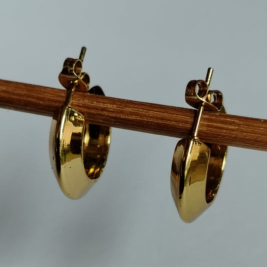 Anti-tarnish Golden Hoop earrings on a Wooden Stick against a White Background