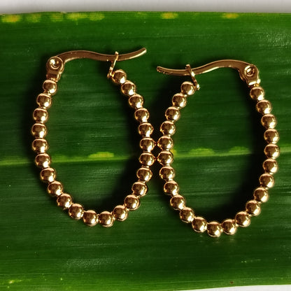 Golden Hoops on a Green Leaf
