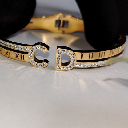 Anti-tarnish Golden Bracelet with Roman Numeral Imprints and American Diamonds  on a Reflective Surface