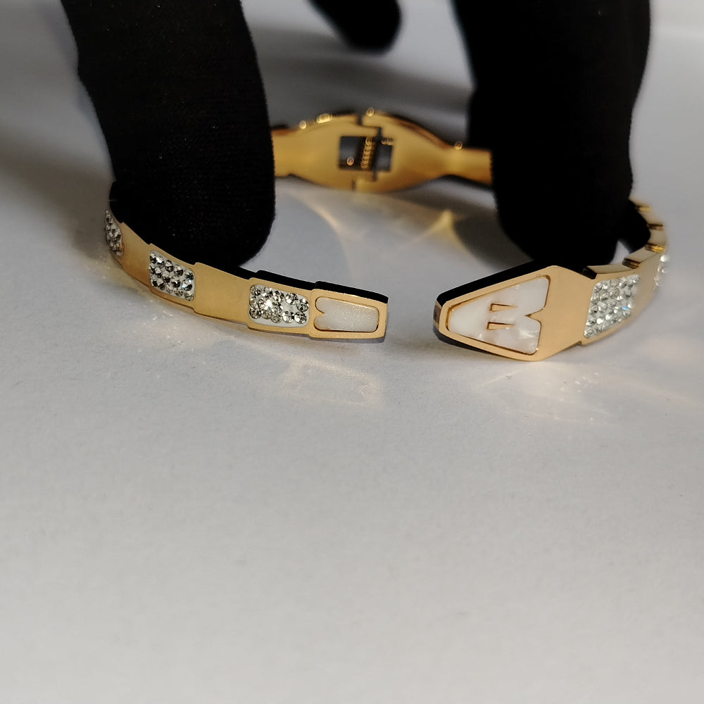 Golden Snake Hood Bracelet with Diamond accents Held Open by Black Gloved Hand