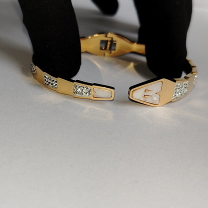 Golden Snake Hood Bracelet with Diamond accents Held Open by Black Gloved Hand