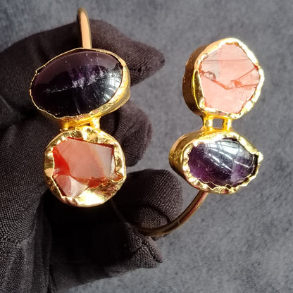 Sleek Golden Bracelet with Carnelian and Amethyst on Either End Held by Hand in Black Gloves