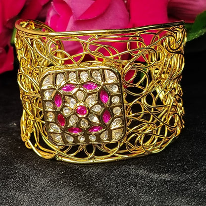 Filigree Golden Bracelet with Pink Stone against Roses