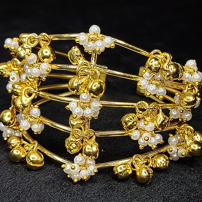 Bracelet with Golden and Pearl Beads on a Black Surface