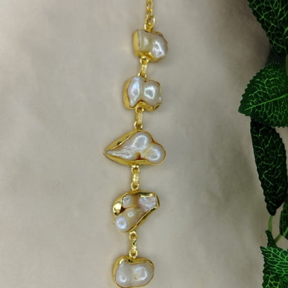 Golden Bracelet. with Natural Pearls on a Beige Background