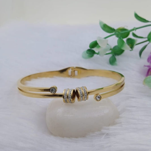 Golden Bracelet with Drums Motif and American Diamond Accents on Fury WHite Background