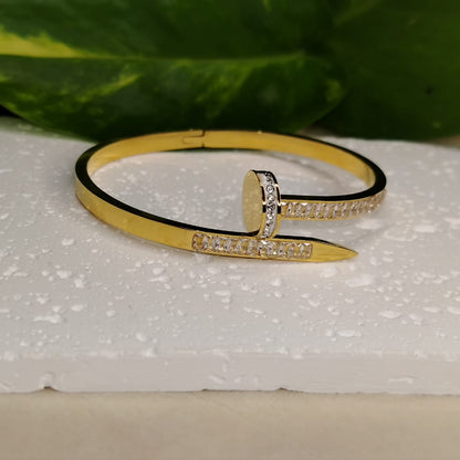 Golden Bracelet with Bracket Setting American Diamonds n a White Textured Background
