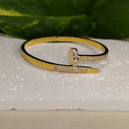 Golden Bracelet with Bracket Setting American Diamonds n a White Textured Background