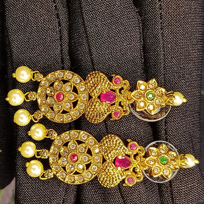 Golden Earrings with Crystals and Pearl Beads on a Black Background