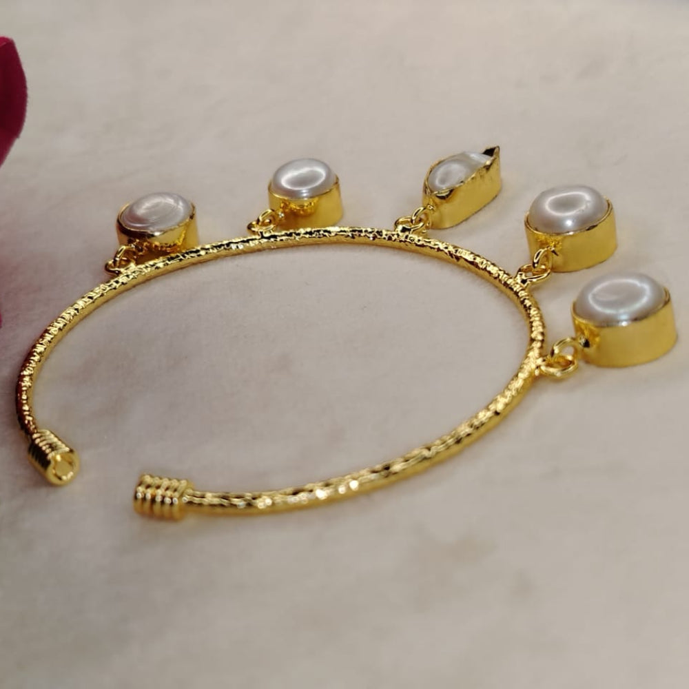 Golden Bracelet with Pearl Charms on a Light Background