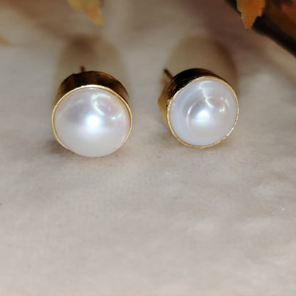 Natural Pearls Earrings on a Beige Background