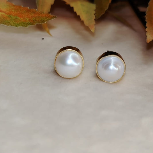Gold Plated Single Natural Pearl Studs on White Background and Autumn LEaves