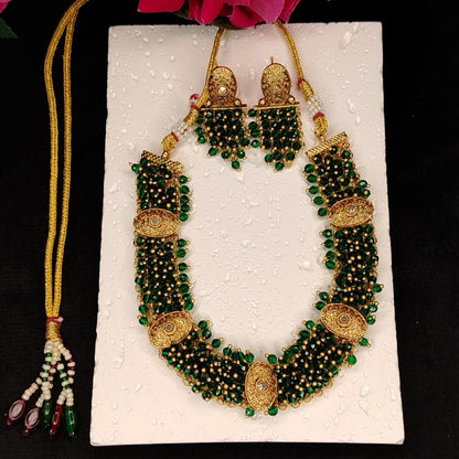 Handworked Handbeaded Necklace and Earrings Set on White Surface