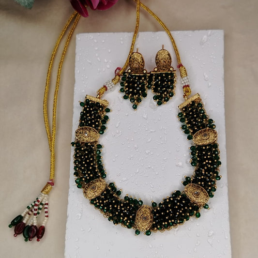 Green Hand-beaded Handworked Necklace with earrings on a White Background