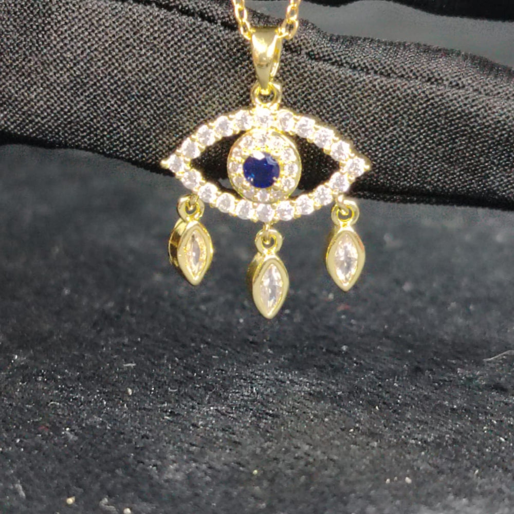 Golden Tear Drop Pendant Centered with Blue Crystal against Black Surface