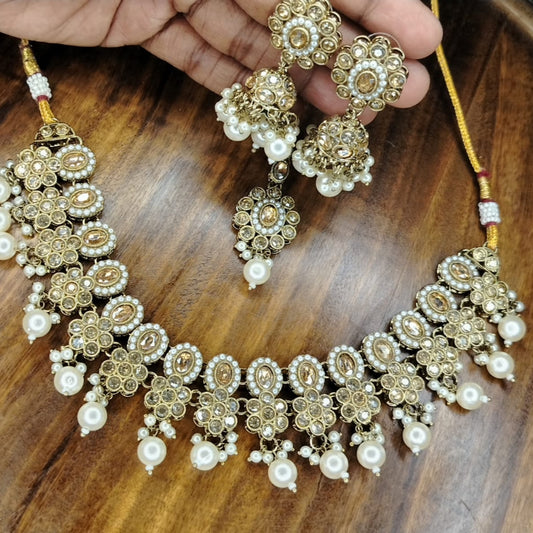 Golden Pearl Beads and Kundan Jewellery Set on A Wooden Surface