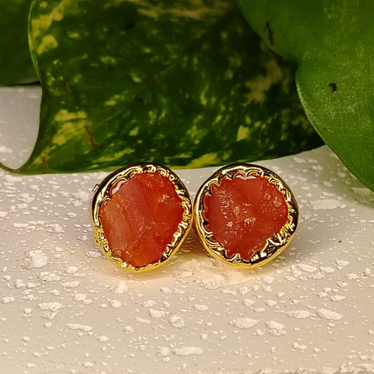 Carnelian Studs on a White Surface against Leaves