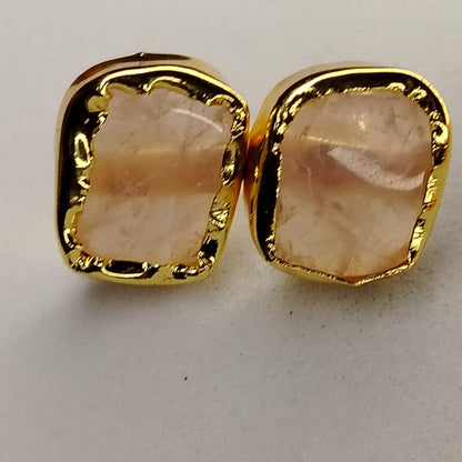 Gold-framed Pink Stone earrings on  aWhite Surface