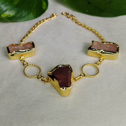 Gold bracelet with Rose Quartz and Garnet Stone on a neutral background