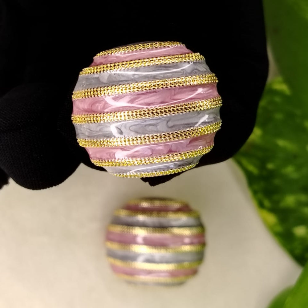 Spherical Earrings with Multicolored Enamel Held in Black Gloved Hand