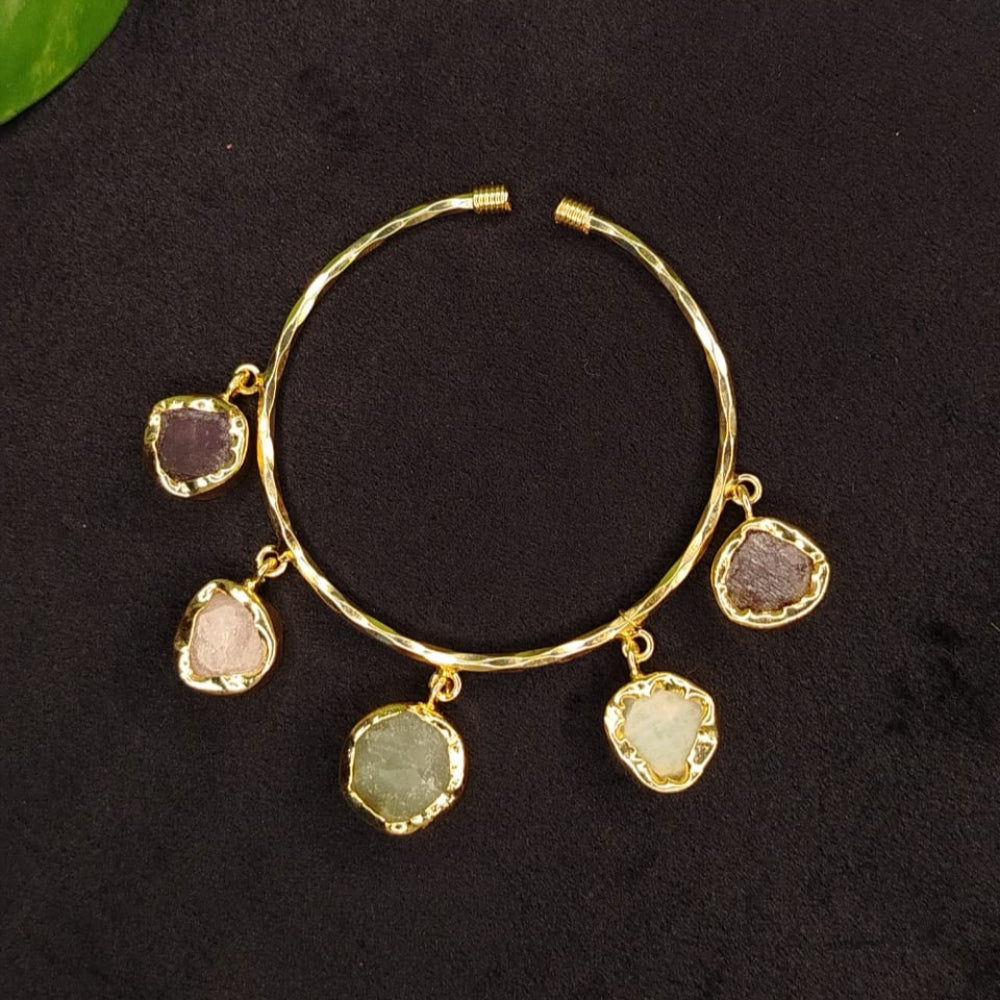 Golden Bracelet with Natural Gemstnes on a dark Surface