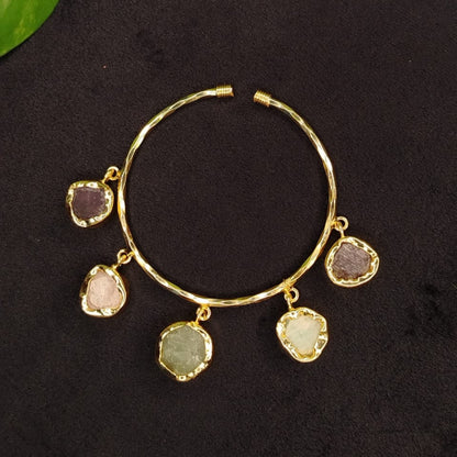 Golden Bracelet with Natural Gemstnes on a dark Surface