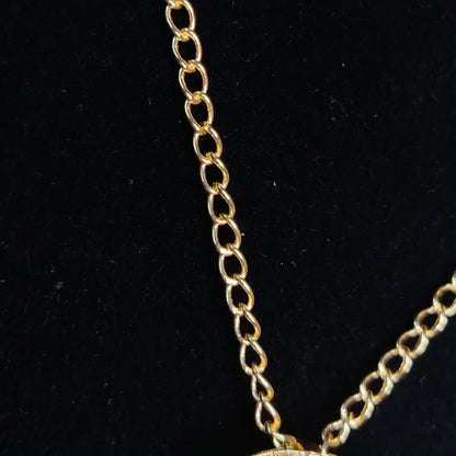 Gold chain necklace on a black background