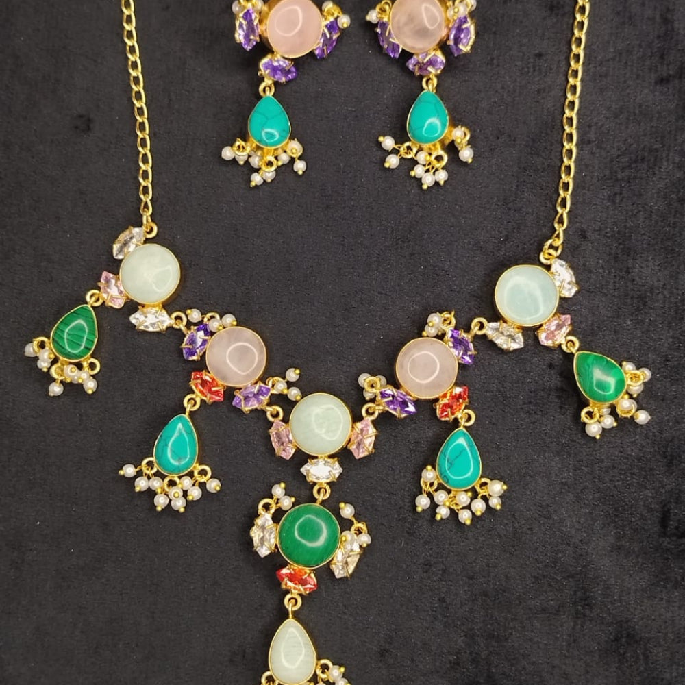 Gold necklace with colorful gemstones on a dark background