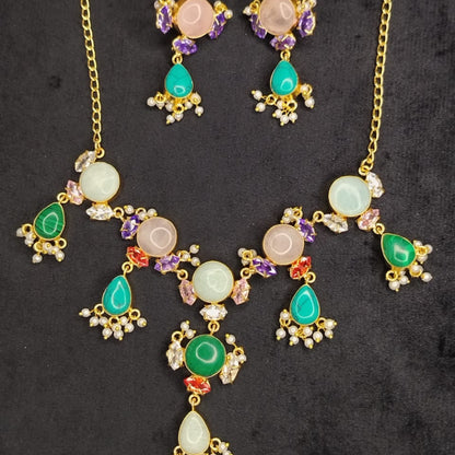 Gold necklace with colorful gemstones on a dark background