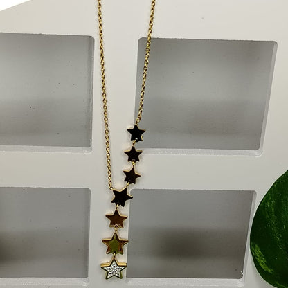 Golden anti-tarnish necklace with star pendants on a white stand