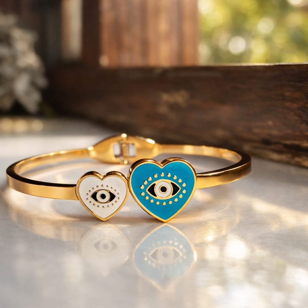 Golden Dual Evuil eye in heart Motif Bracelet on White reflective surface